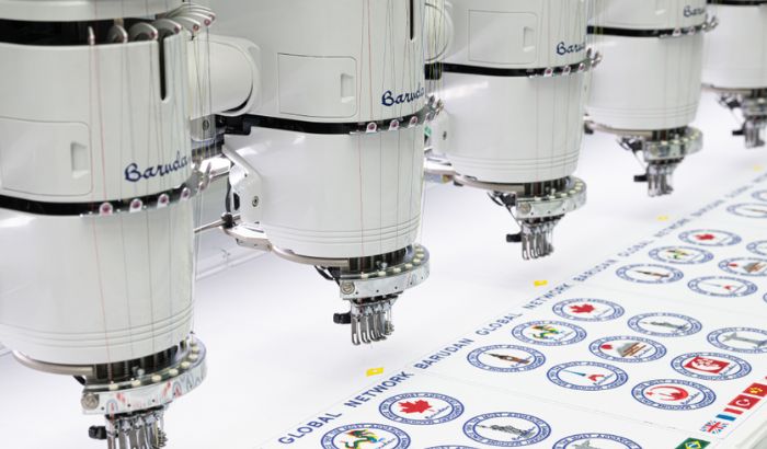 Multi-head embroidery machine stitching badges