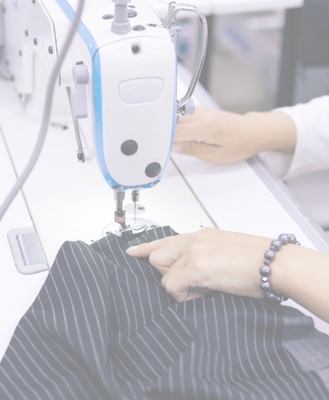 Tailor stitching a jacket on a lockstitch machine